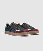 Colorful suede sneakers with navy, burgundy, green, and purple accents on a gum sole