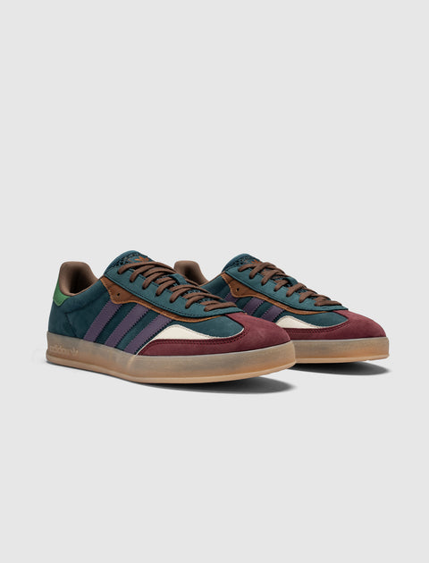 Colorful suede sneakers with navy, burgundy, green, and purple accents on a gum sole