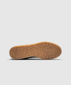Gum sole of navy and purple sneaker with textured Adidas logo pattern