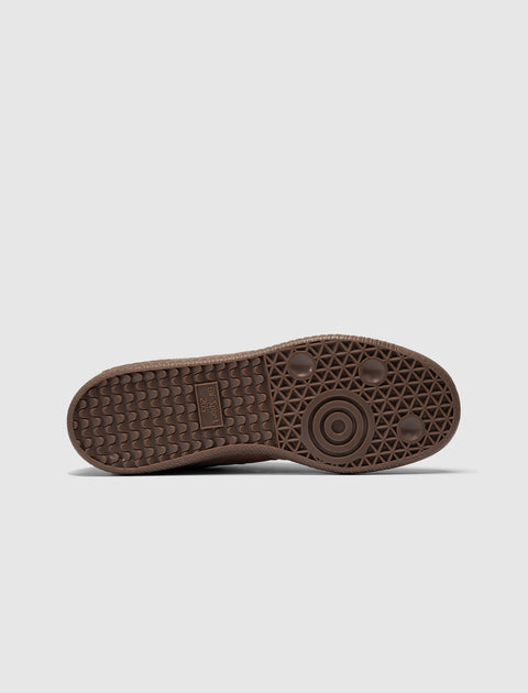 Brown sneaker sole with textured grip pattern on a white background