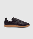 Eggplant purple low-top leather sneaker with gum sole on white background