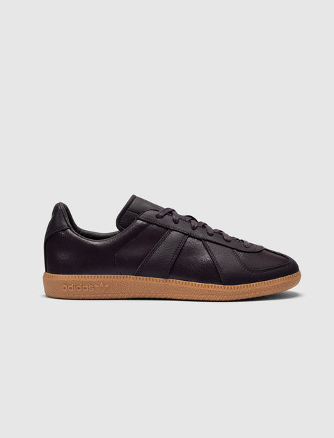 Eggplant purple low-top leather sneaker with gum sole on white background