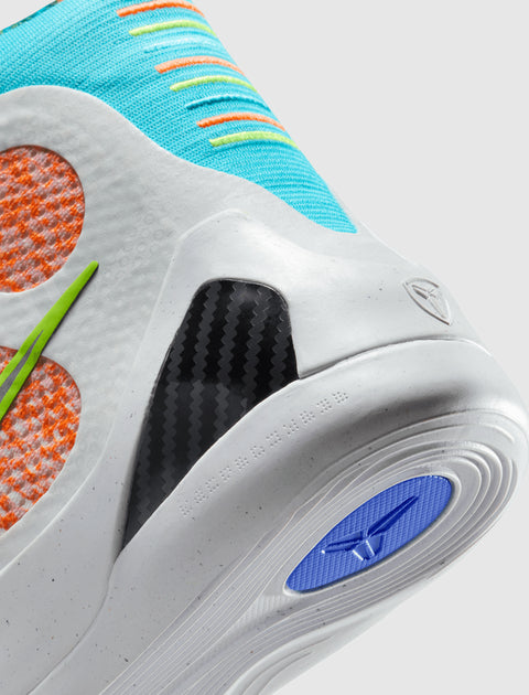 Close-up of colorful athletic sneaker with turquoise upper, orange details, and carbon fiber heel support