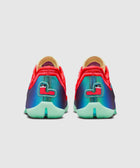 Back view of vibrant multicolor low-top sneakers with teal, red and mint details on white background