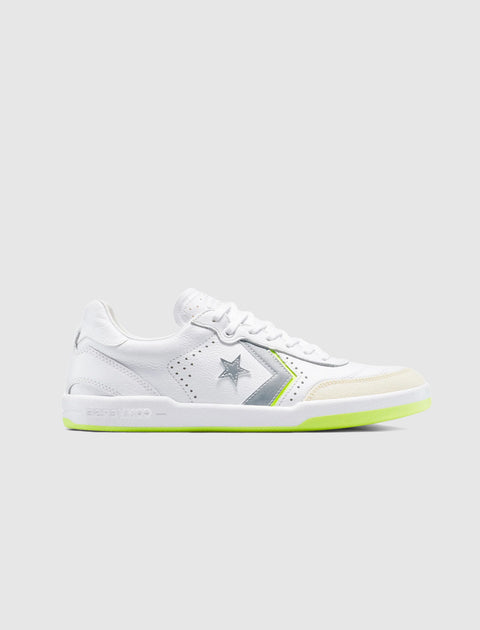 White low-top sneaker with gray star and chevron, neon green sole, side view, on light background