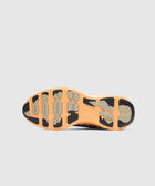 Brown and tan sneaker outsole with textured grip, viewed from the bottom against a gray background.