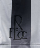 Close-up of black embroidered logo on black and white striped men's streetwear fabric
