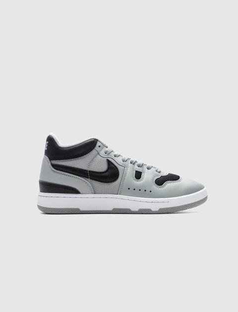 Gray and black men's streetwear sneaker with a white sole on a plain background