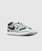 Gray and black leather mid-top sneakers with white soles on a plain background