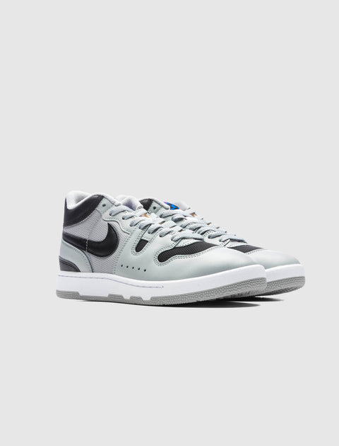 Gray and black leather mid-top sneakers with white soles on a plain background