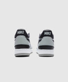 Rear view of gray and black Nike low-top sneakers on a white background.