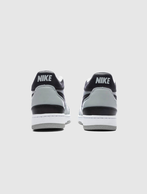 Rear view of gray and black Nike low-top sneakers on a white background.