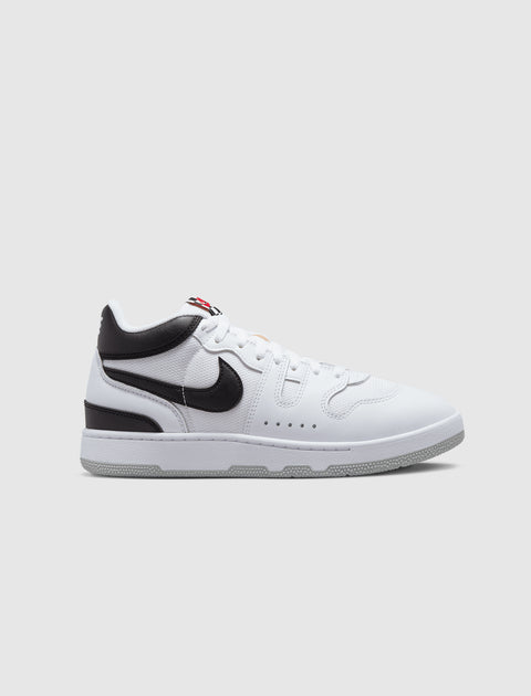White and black low-top sneaker with black swoosh logo and textured sole on gray background
