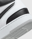 Close-up of black and white leather sneaker with textured rubber sole