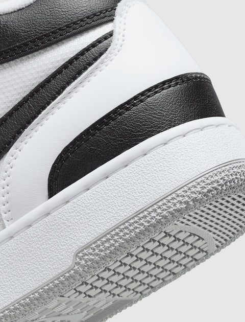 Close-up of black and white leather sneaker with textured rubber sole