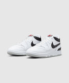 White and black low-top sneakers with checkered tongue detail on a plain background