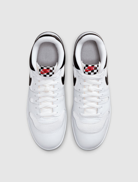 Top view of white low-top sneakers with black accents and checkerboard tongue label