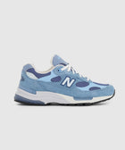 Light blue and navy men's sneaker with white laces and mesh accents, side profile view