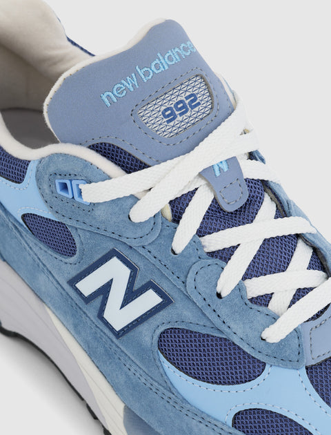 Close-up of New Balance 992 sneaker in blue suede and mesh with white laces