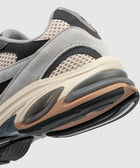 Close-up of a grey and beige suede mesh sneaker with textured sole