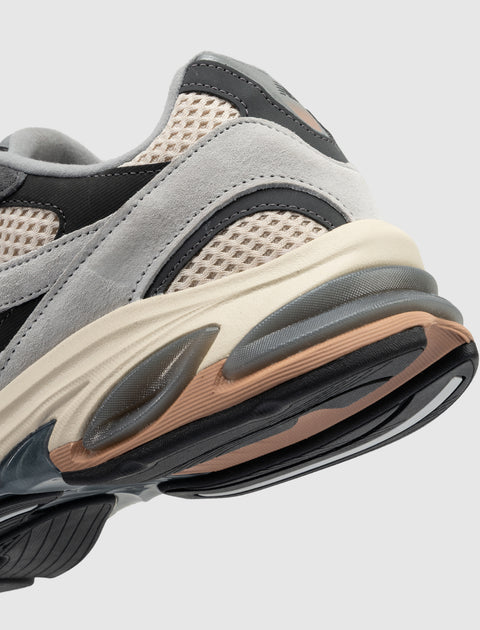 Close-up of a grey and beige suede mesh sneaker with textured sole