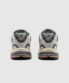 Rear view of grey suede and mesh lifestyle sneakers with black midsole accents
