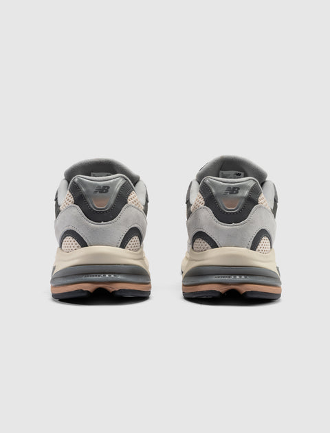Rear view of grey suede and mesh lifestyle sneakers with black midsole accents