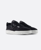 Black low-top sneakers with white soles and '550' detail on the side