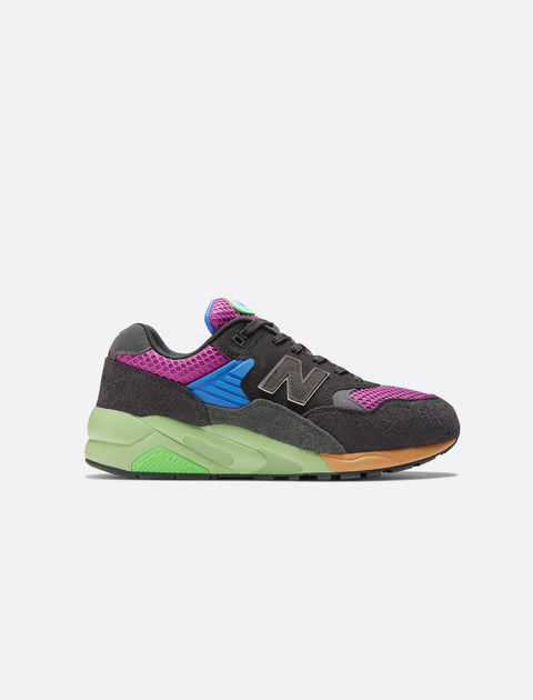 Multicolor men's sneaker with purple mesh, grey suede, green sole, and blue midfoot panel