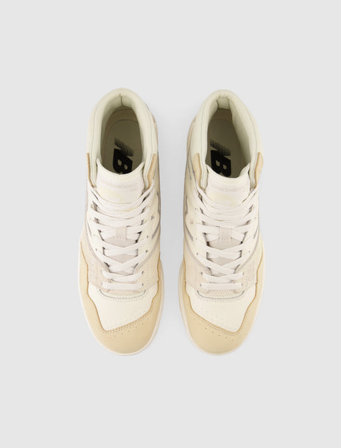 Beige high-top sneakers with white laces and perforated toes, viewed from above