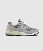 Grey suede and mesh sneaker with white laces, cushioned sole, side profile view