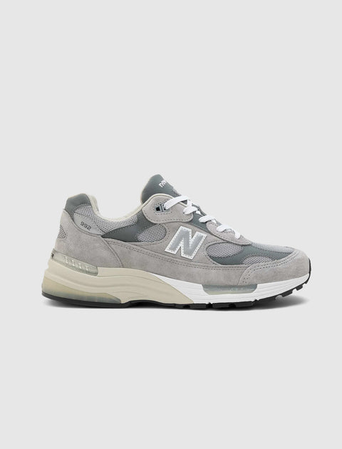 Grey suede and mesh sneaker with white laces, cushioned sole, side profile view