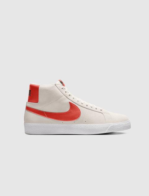 Men’s high-top sneaker in light grey with orange swoosh, white sole, side view on white background
