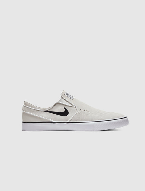 White slip-on sneaker with black swoosh logo and white sole, side profile view