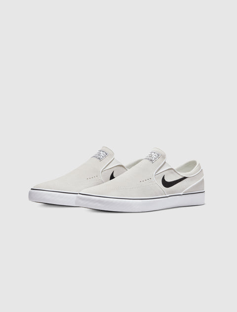 White slip-on skate sneakers with black swoosh logo and white rubber sole on plain background