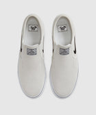 White slip-on skate shoes with black Swoosh logo, top view on plain background