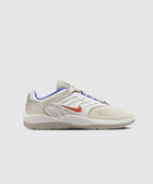 White and beige low-top sneaker with orange Swoosh and blue trim on a plain background