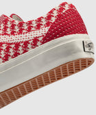 Red and white houndstooth low-top sneaker with waffle sole and rubber heel tab