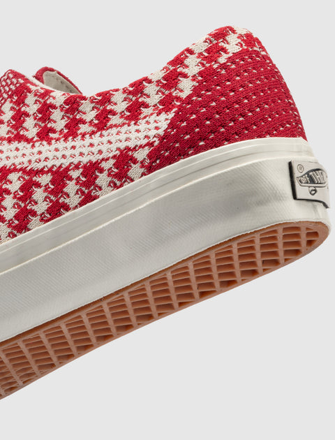 Red and white houndstooth low-top sneaker with waffle sole and rubber heel tab