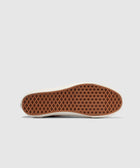 Brown waffle sole of a streetwear sneaker on white background, men's footwear detail