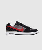 Black, grey, and red low-top sneaker with white sole and visible air unit, side profile