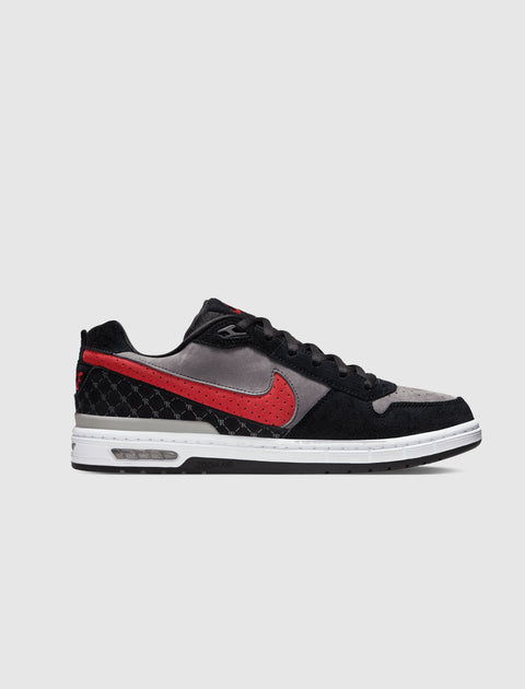 Black, grey, and red low-top sneaker with white sole and visible air unit, side profile