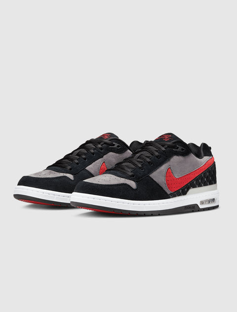 Pair of low-top sneakers with black, grey, and red suede panels, white midsole, and black laces