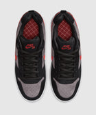 Top view of black and grey suede sneakers with red accents and Nike SB logo
