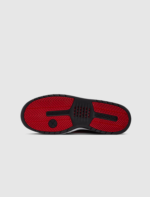 Black and red rubber sneaker sole with textured grip and jumpman logo on light background