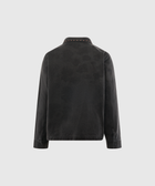 Back view of black denim jacket with studded collar and long sleeves on plain background