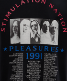 Black streetwear top with graphic of four women in white head coverings, Stimulation Nation text and city tour list, Pleasures 1991 design.