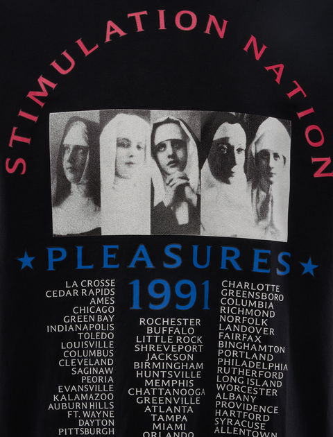 Black streetwear top with graphic of four women in white head coverings, Stimulation Nation text and city tour list, Pleasures 1991 design.