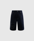 Dark denim streetwear shorts with stitched skull graphic on left leg, front view