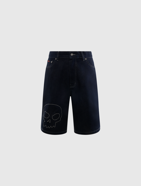 Dark denim streetwear shorts with stitched skull graphic on left leg, front view